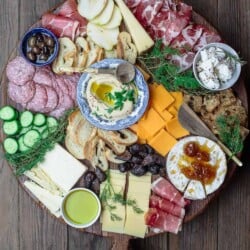 Best Cheese Board with assorted cheeses, cured meats, olives, cucumbers, and dried fruits