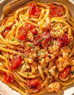 Lobster pasta in a bowl with a fork.
