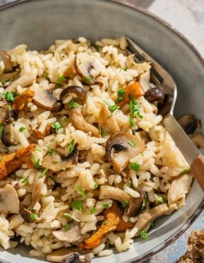 A serving of mushroom rice in a bowl with a fork.