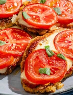 A close up of the pieces of baked cauliflower parmesan on a platter.