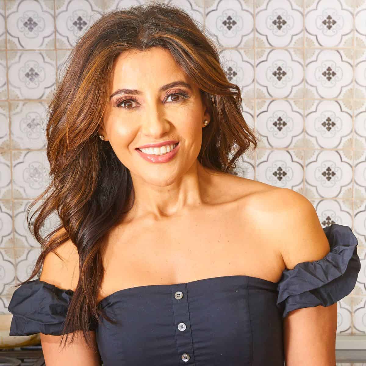 A headshot of Suzy Karadsheh from The Mediterranean Dish in her kitchen.