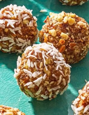 A close up of one energy ball on a platter surrounded by other energy balls.