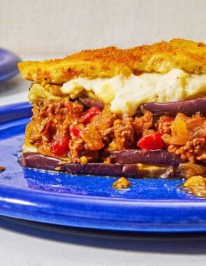 A close up of a serving of moussaka on a plate.