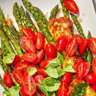 Roasted Asparagus Salad with Fried Halloumi and Fresh Tomatoes on a serving platter.